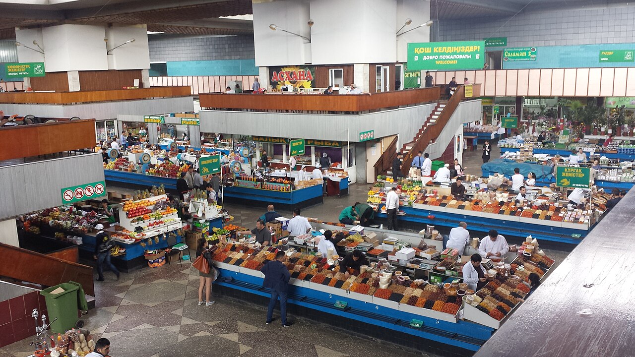 Shoppers inside Almaty’s Green Bazaar, a busy but easygoing public market where petty scams are rare