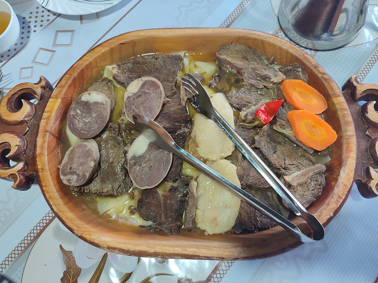 A wooden platter of beshbarmak, Kazakhstan’s national dish — a filling restaurant meal that still costs only a few dollars
