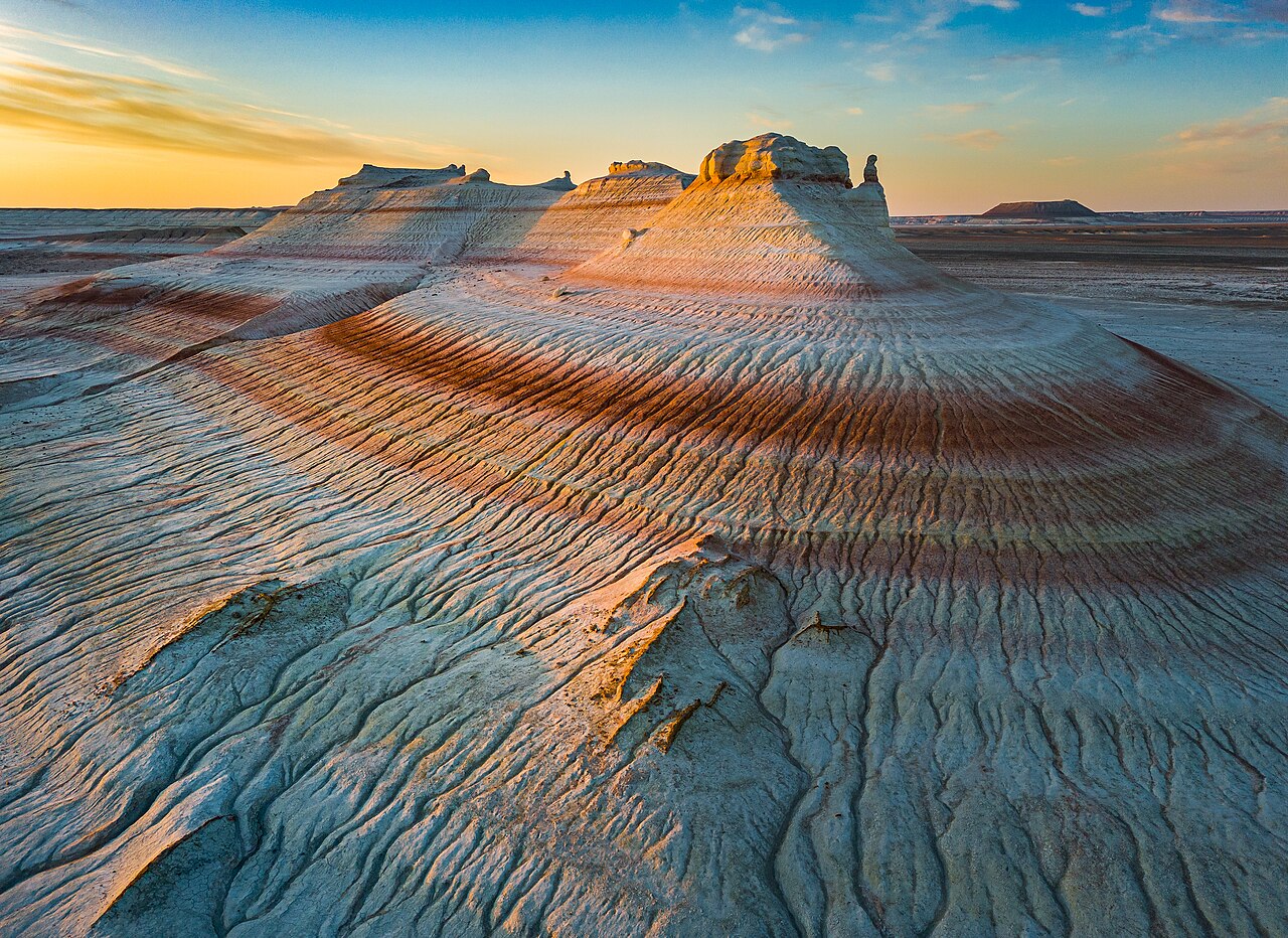 Dawn on the striped clay and chalk hills of Kyzylkup, the formation guides nicknamed the Tiramisu