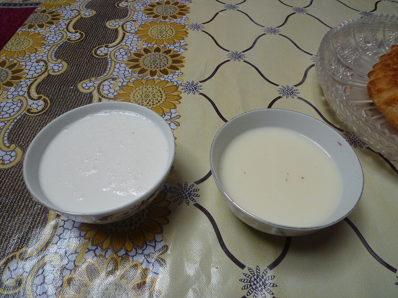 Bowls of shubat and kumis served with baursak