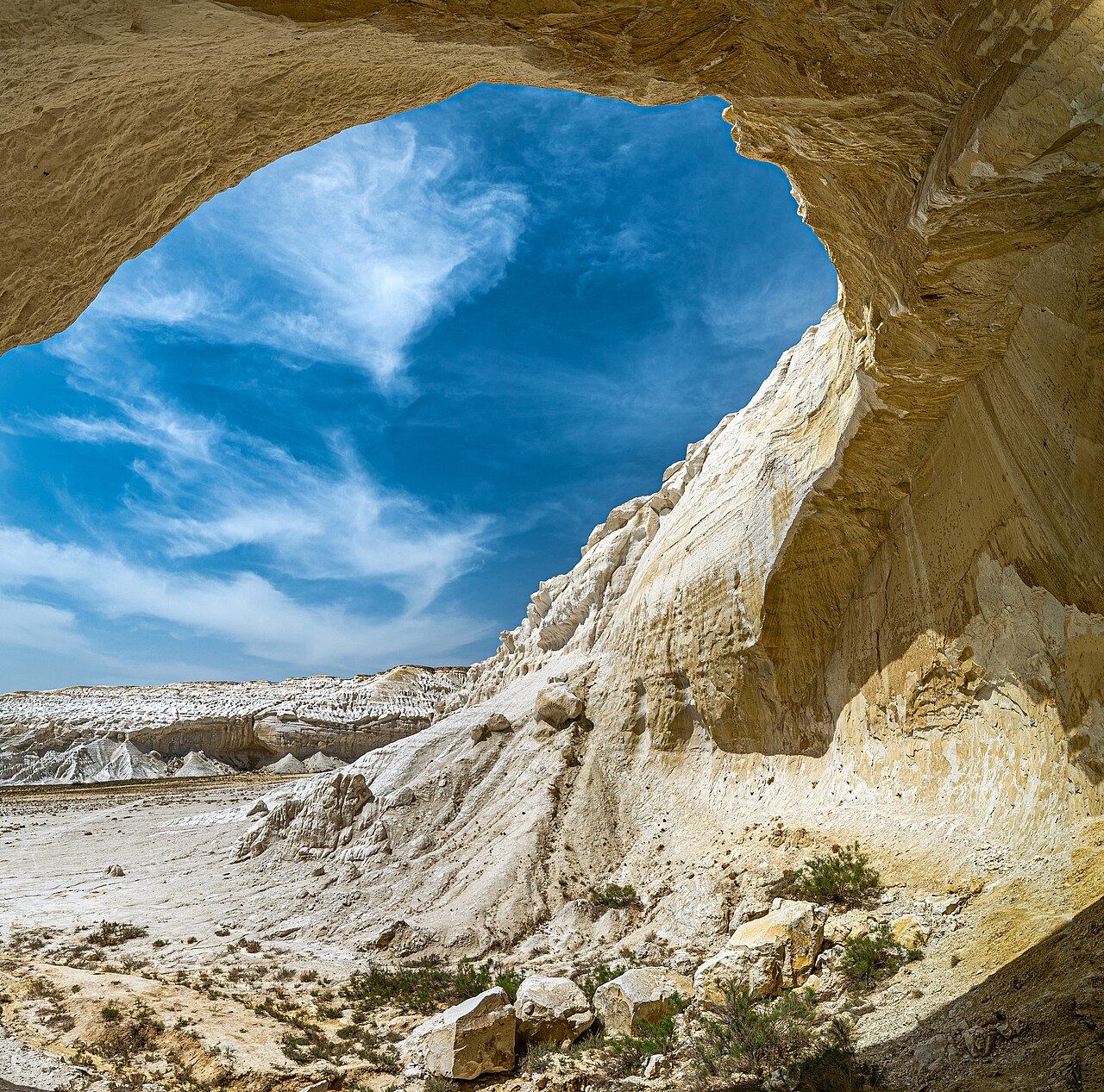 Looking out through the Tuzbair arch onto the white salt crust of the sor below